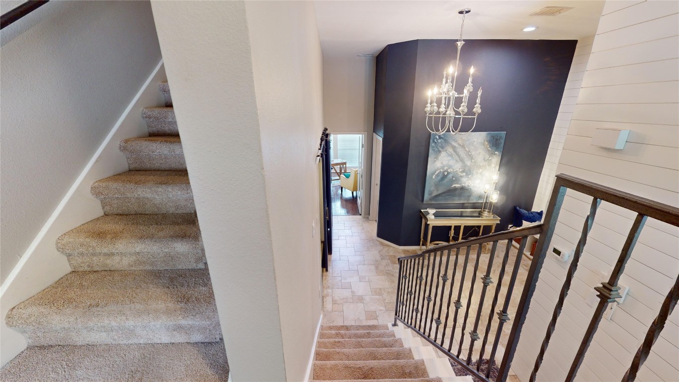 2918 Ranch Road 620, Unit 297 Austin, TX 78734 - Photo 23 of 37 Stairs with a chandelier, wooden walls, and recessed lighting