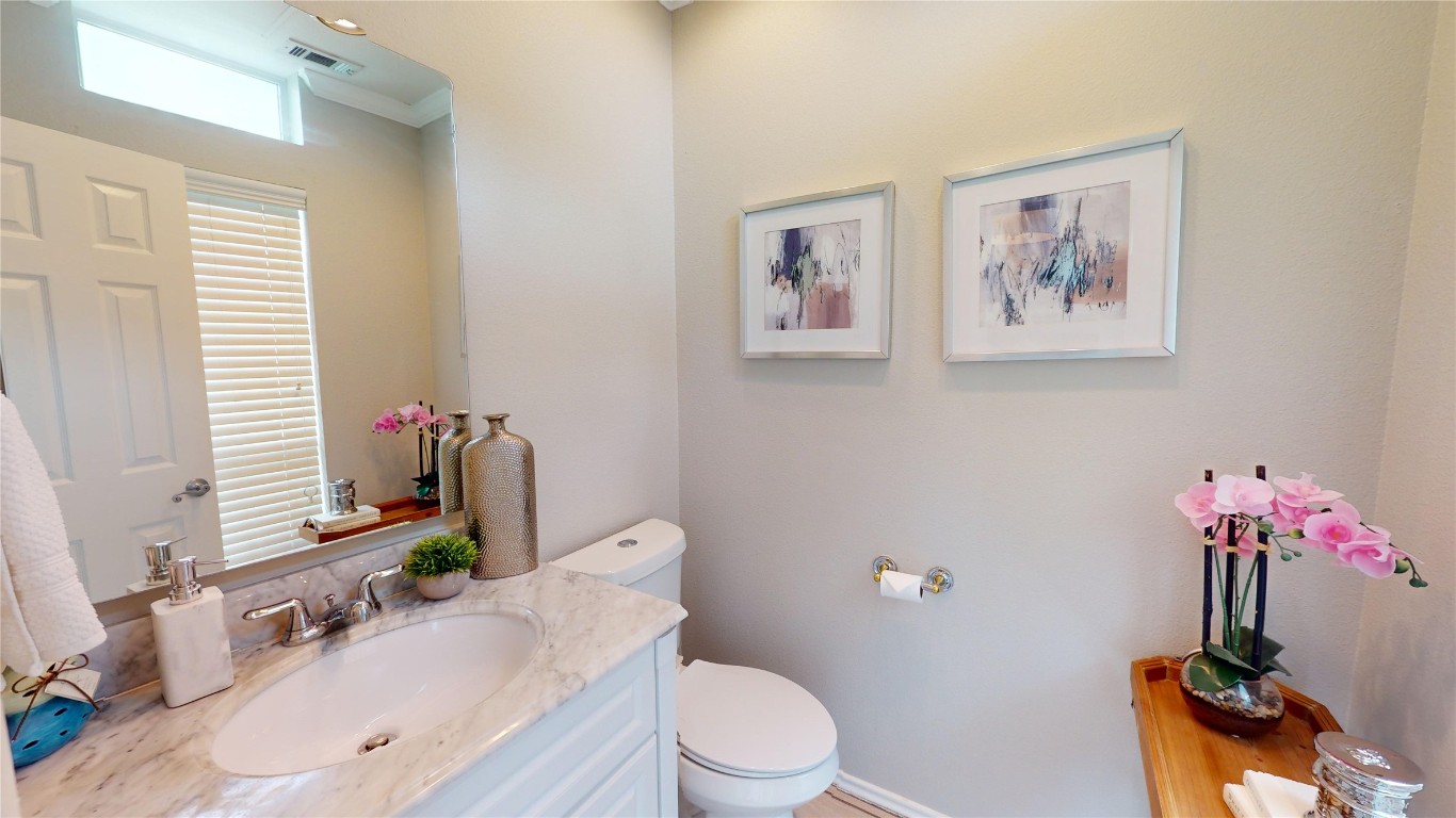 2918 Ranch Road 620, Unit 297 Austin, TX 78734 - Photo 24 of 37 Half bath with vanity and crown molding