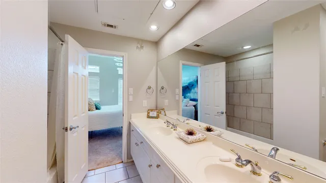 a bathroom with a tub sink and mirror