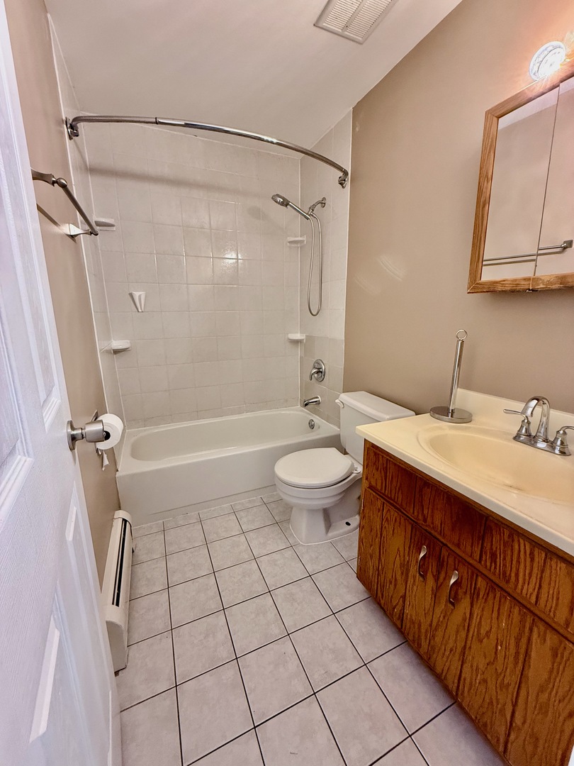 3823 West 123rd Street, Unit 302 Alsip, IL 60803 - Photo 21 of 40 a bathroom with a sink a toilet and shower