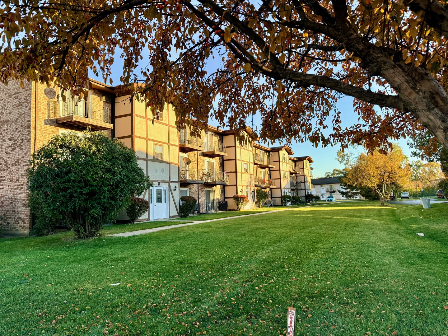 3823 West 123rd Street, Unit 302 Alsip, IL 60803 - Photo 39 of 40 a view of a building with a big yard and large trees