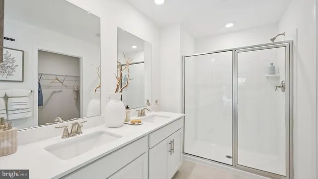 a bathroom with a double vanity sink mirror and double