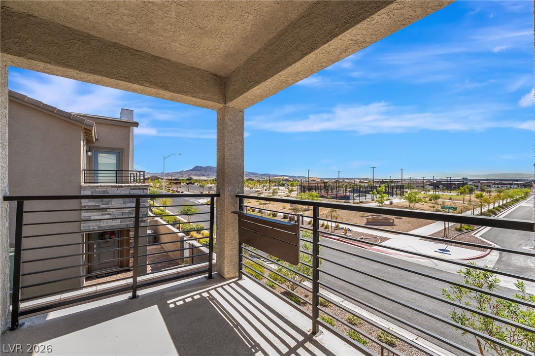 894 Cadence View Way Henderson, NV 89011 - Photo 18 of 23 A spacious balcony offers sweeping views of the neighborhood and distant mountains, ideal for relaxation.