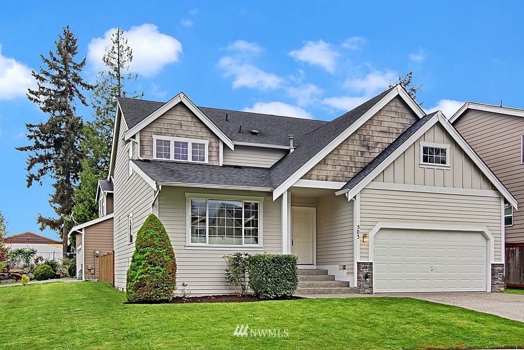 503 Ilwaco Avenue Northeast Renton, WA 98059 - Photo 2 of 17 a front view of a house with a garden