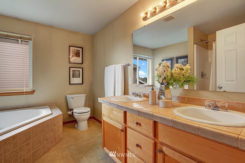503 Ilwaco Avenue Northeast Renton, WA 98059 - Photo 11 of 17 a bathroom with a granite countertop sink mirror vanity and toilet