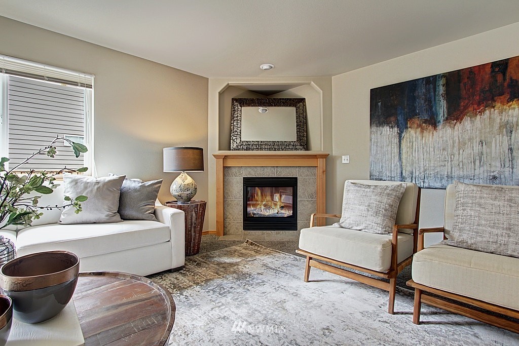 503 Ilwaco Avenue Northeast Renton, WA 98059 - Photo 4 of 17 a living room with furniture and a fireplace