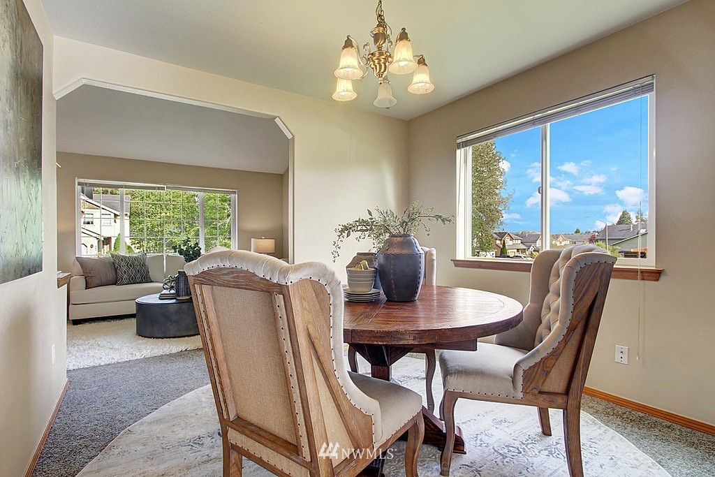 503 Ilwaco Avenue Northeast Renton, WA 98059 - Photo 5 of 17 a view of a dining room with furniture window and outside view