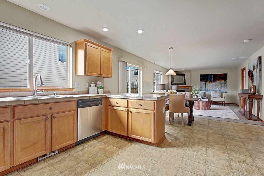 503 Ilwaco Avenue Northeast Renton, WA 98059 - Photo 7 of 17 a kitchen with sink cabinets and window