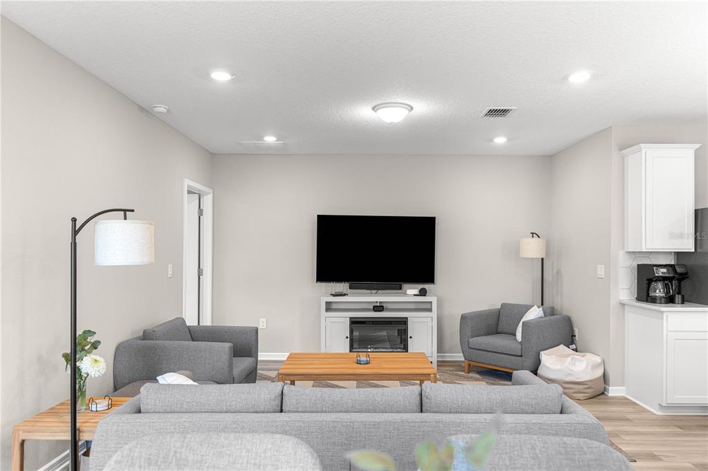 5466 Southwest 85th Ave Road Ocala, FL 34481 - Photo 14 of 36 a living room with furniture and a flat screen tv