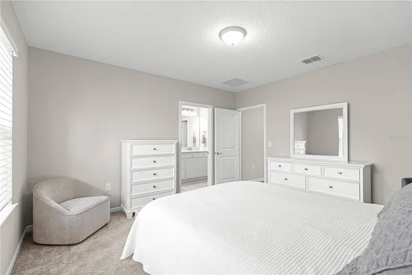 a bedroom with a bed and a couch