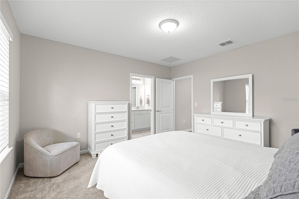 5466 Southwest 85th Ave Road Ocala, FL 34481 - Photo 15 of 36 a bedroom with a bed and a couch