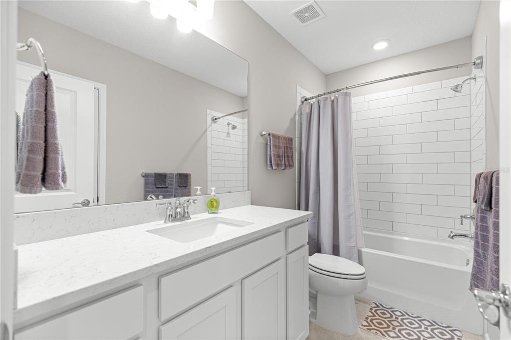 5466 Southwest 85th Ave Road Ocala, FL 34481 - Photo 22 of 36 a bathroom with a sink a toilet a mirror and shower