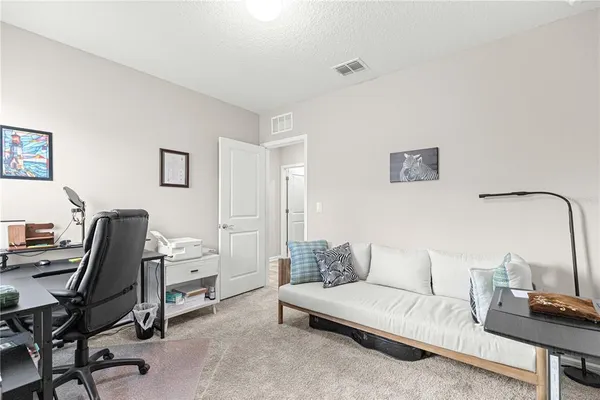 a view of a livingroom with workspace and a couch