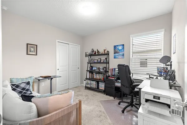 a bedroom with furniture and large windows