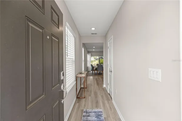 a view of hallway with wooden floor
