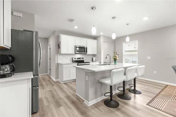 a kitchen with counter space cabinets and appliances