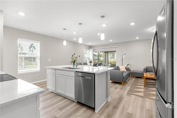 a large white kitchen with a large window