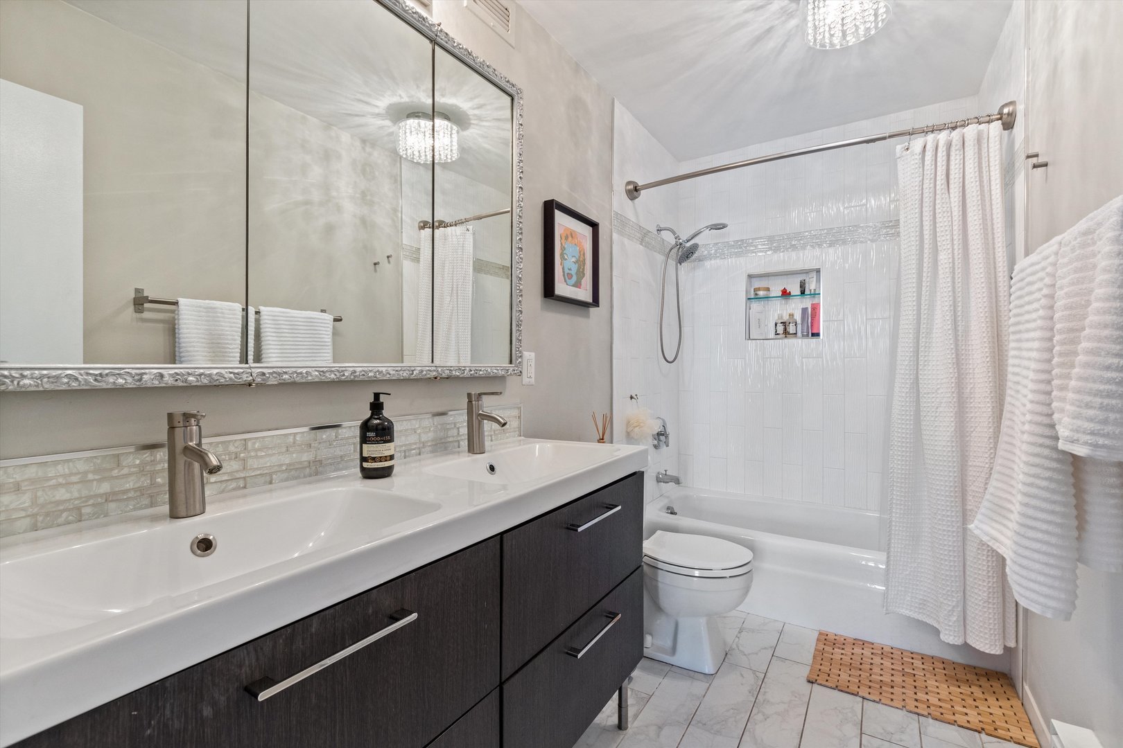 6033 North Sheridan Road, Unit 21D Chicago, IL 60660 - Photo 12 of 22 a bathroom with a double vanity sink toilet and shower