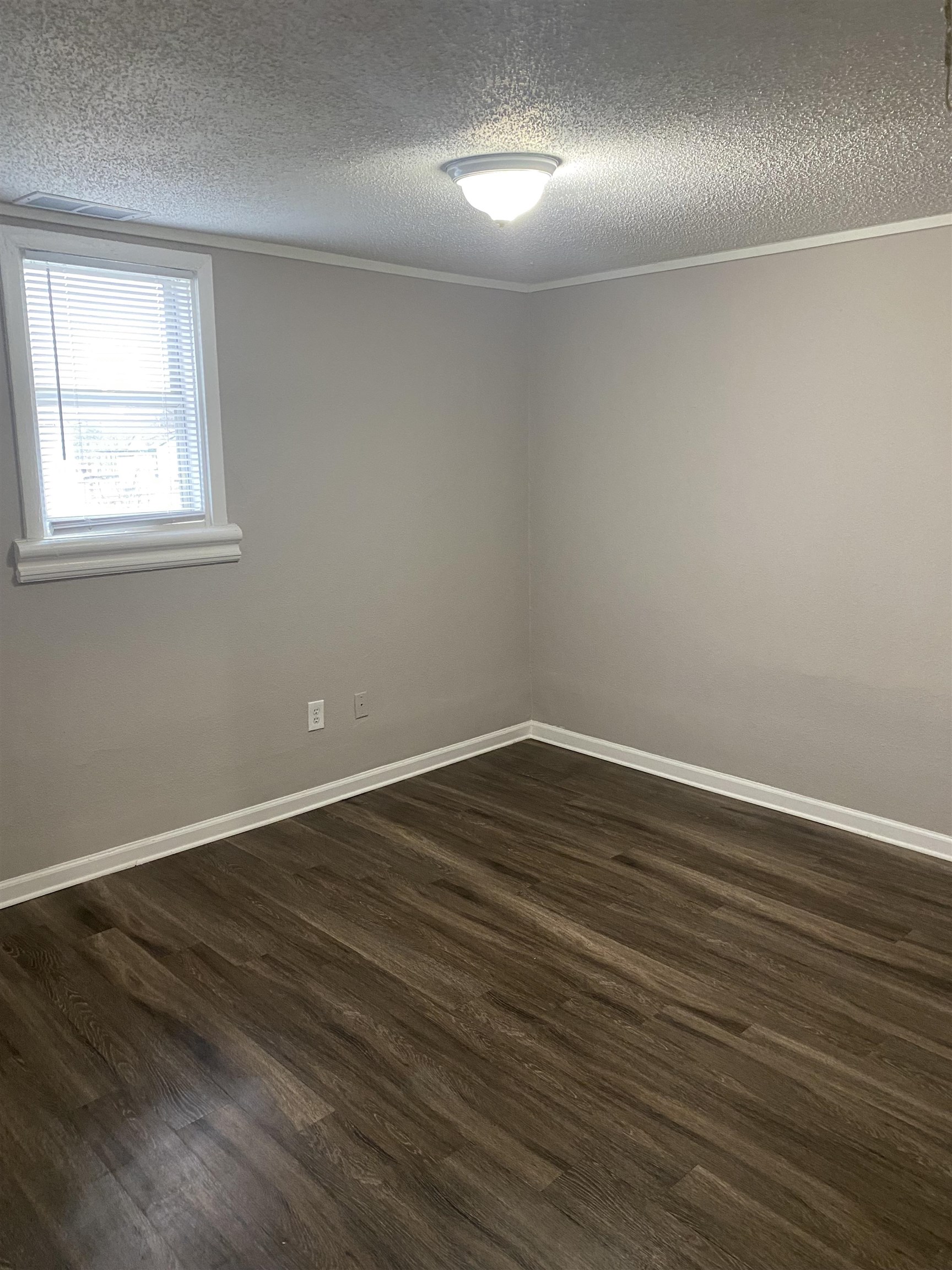 3219 Nathan Avenue Memphis, TN 38112 - Photo 11 of 23 an empty room with wooden floor and windows