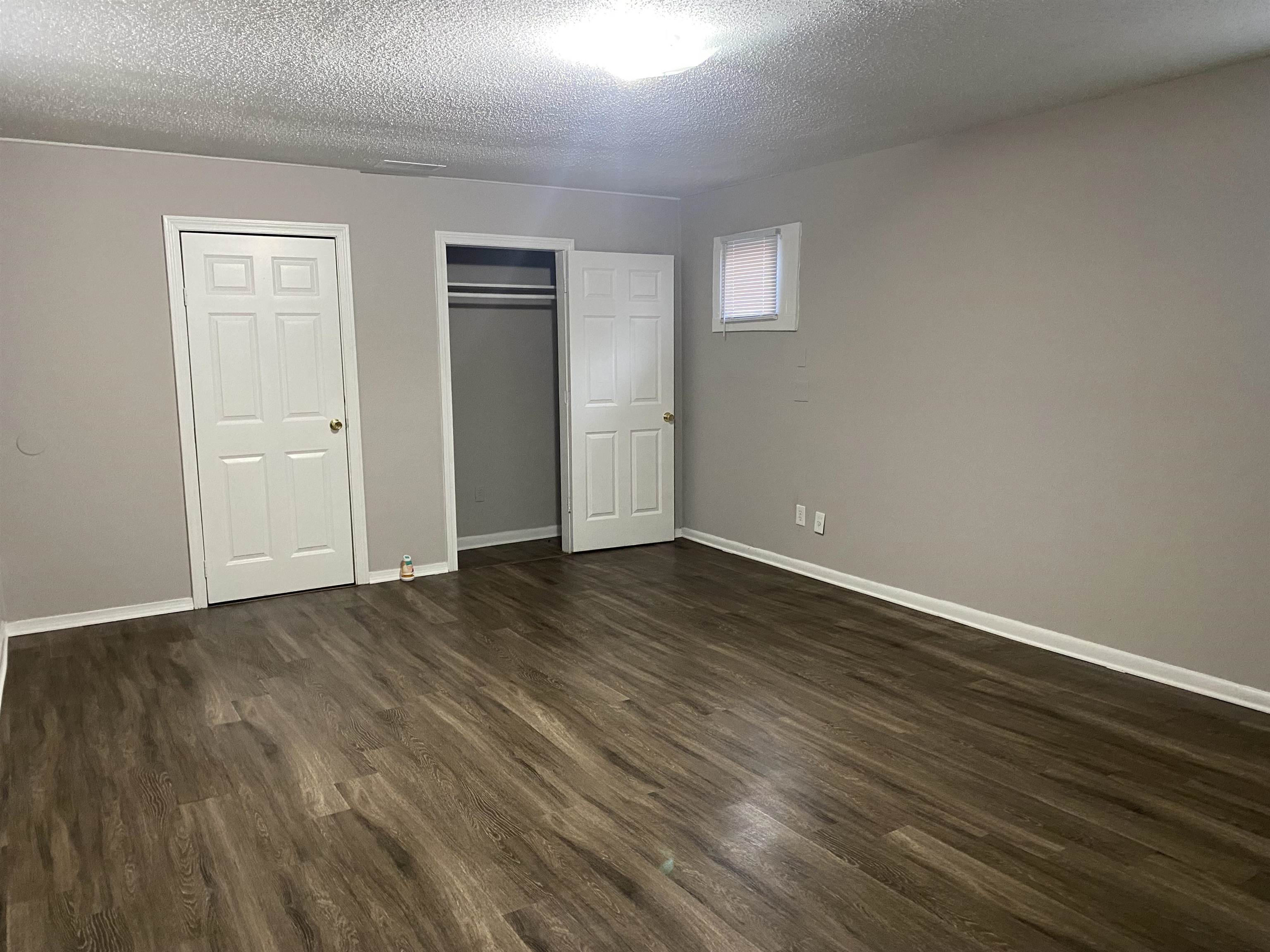 3219 Nathan Avenue Memphis, TN 38112 - Photo 17 of 23 a view of an empty room with wooden floor and closet
