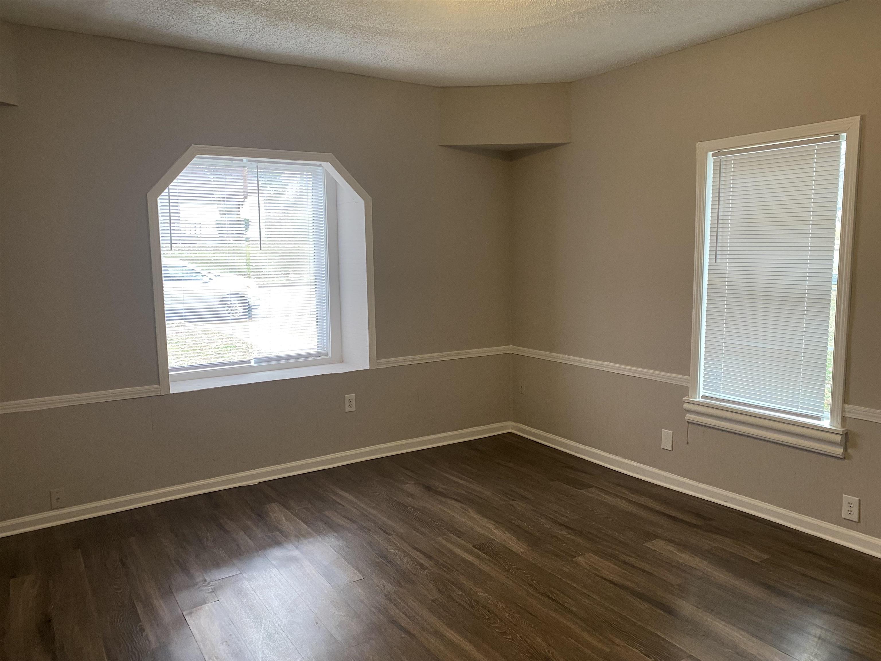 3219 Nathan Avenue Memphis, TN 38112 - Photo 8 of 23 an empty room with wooden floor and windows