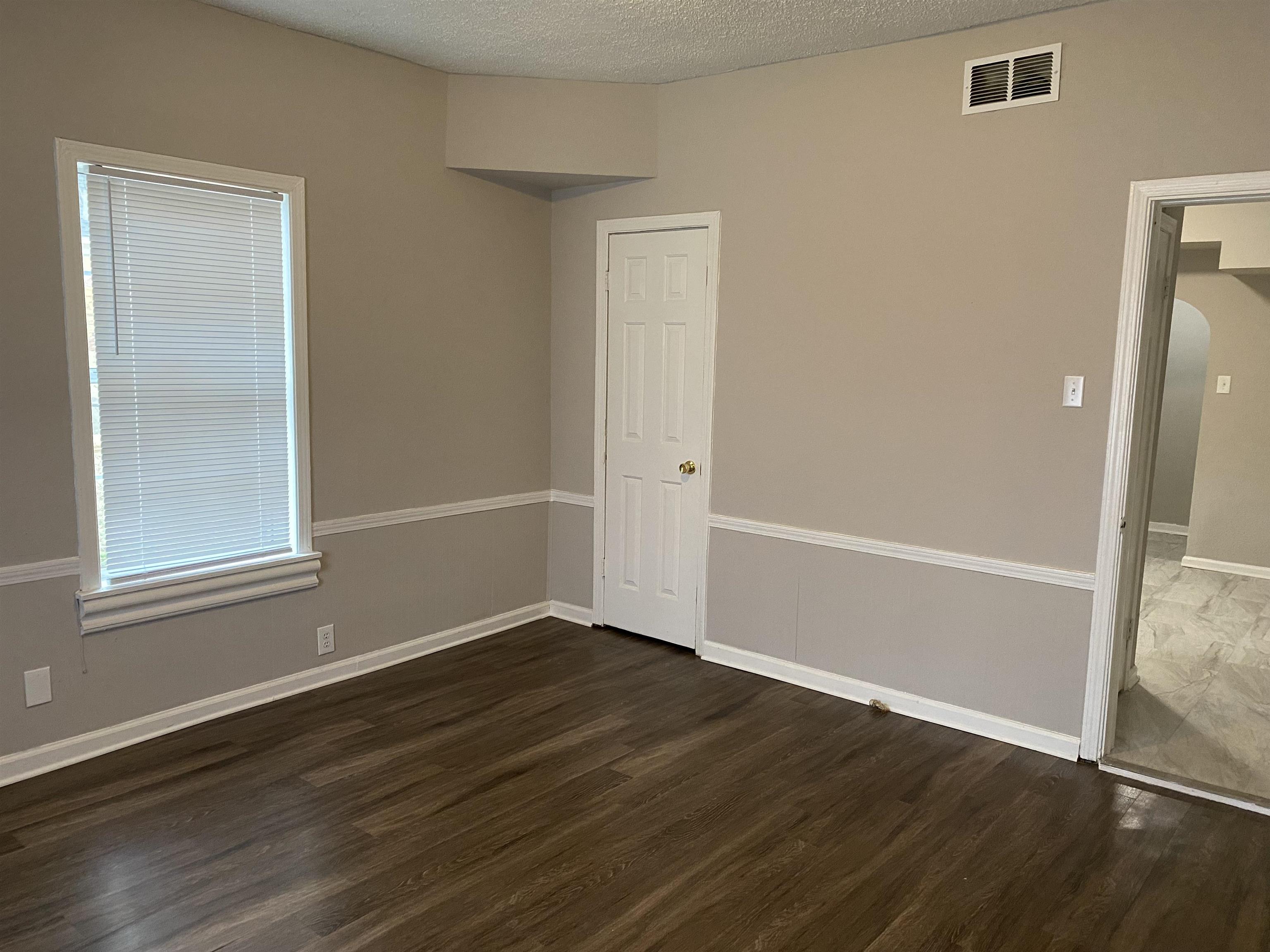 3219 Nathan Avenue Memphis, TN 38112 - Photo 9 of 23 an empty room with wooden floor and windows