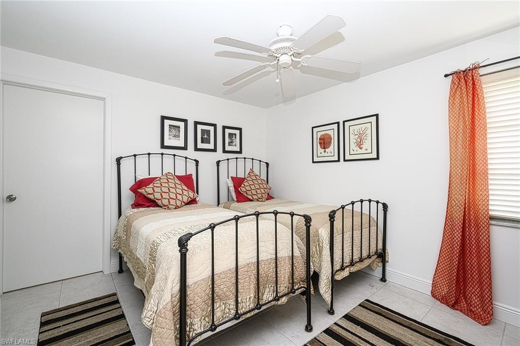 637 12th Avenue South, Unit 637 Naples, FL 34102 - Photo 11 of 35 a bedroom with a bed and a window