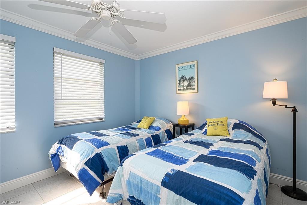 637 12th Avenue South, Unit 637 Naples, FL 34102 - Photo 12 of 35 a bedroom with two beds and a window