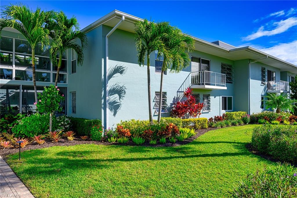 637 12th Avenue South, Unit 637 Naples, FL 34102 - Photo 2 of 35 a front view of a house with garden