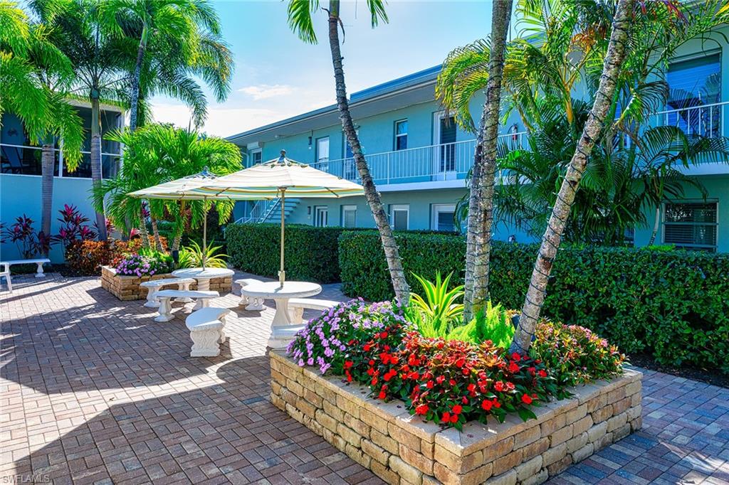 637 12th Avenue South, Unit 637 Naples, FL 34102 - Photo 3 of 35 a view of a chairs and tables in patio