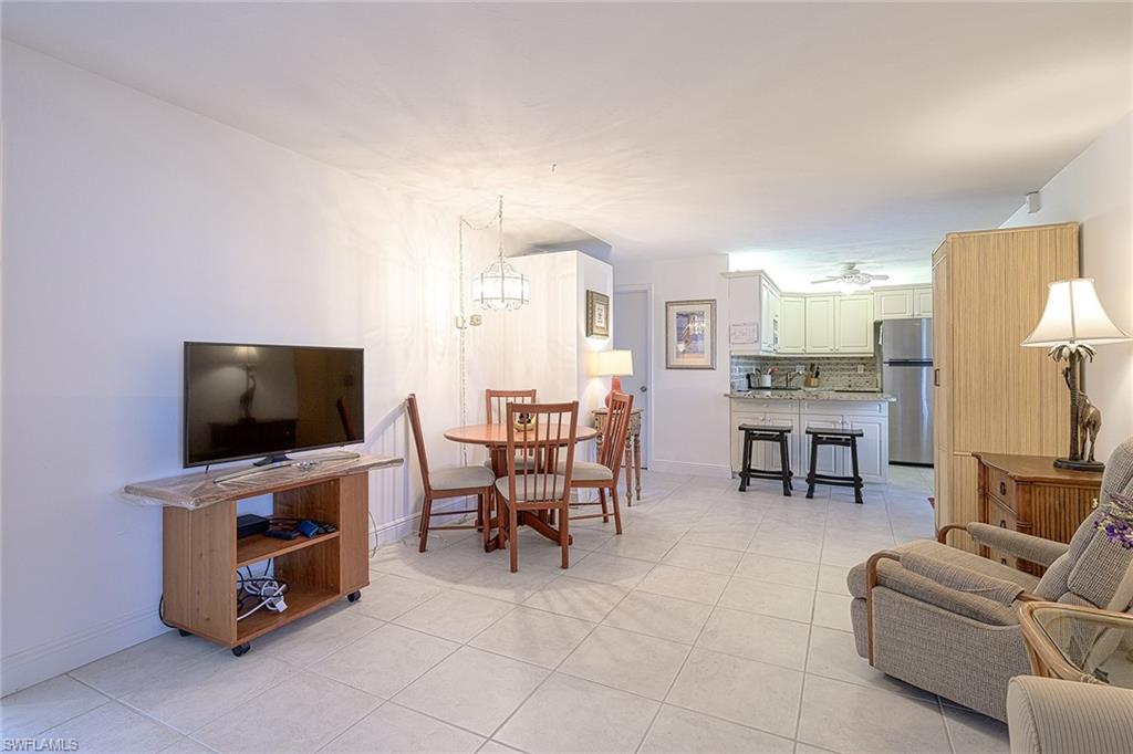 637 12th Avenue South, Unit 637 Naples, FL 34102 - Photo 7 of 35 a living room with furniture and a flat screen tv