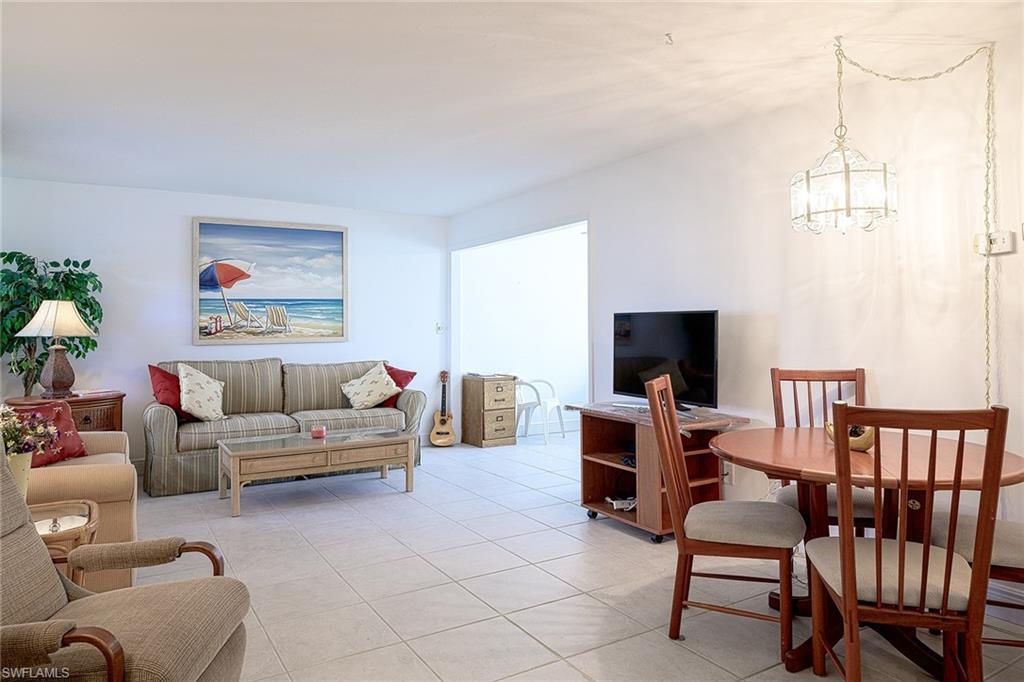 637 12th Avenue South, Unit 637 Naples, FL 34102 - Photo 9 of 35 a living room with furniture and a flat screen tv