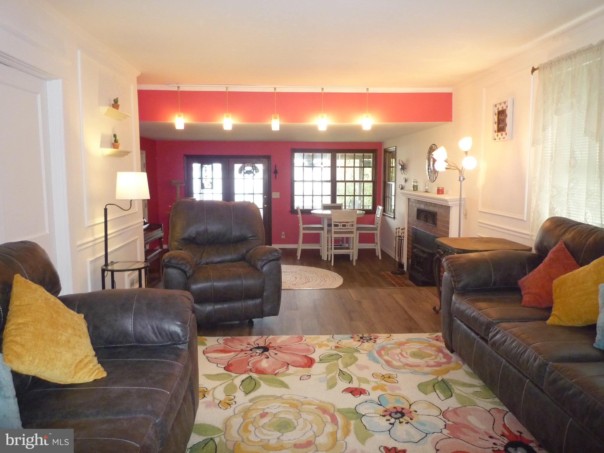 1315 Wildwood Beach Road Essex, MD 21221 - Photo 16 of 56 a living room with furniture and a fireplace
