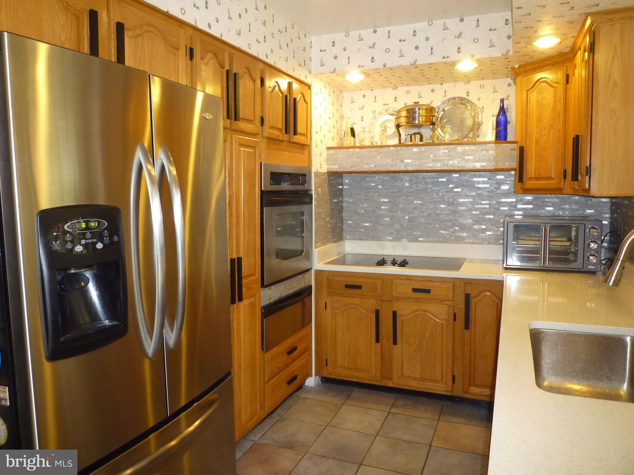 1315 Wildwood Beach Road Essex, MD 21221 - Photo 9 of 56 a kitchen with stainless steel appliances granite countertop a refrigerator and a sink