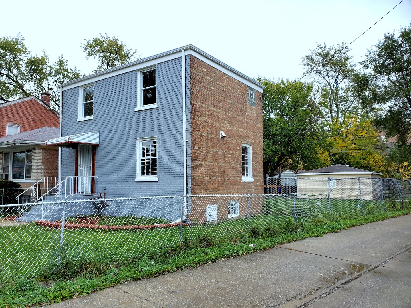 653 East 105th Street Chicago, IL 60628 - Photo 2 of 27 a front view of a house with a yard