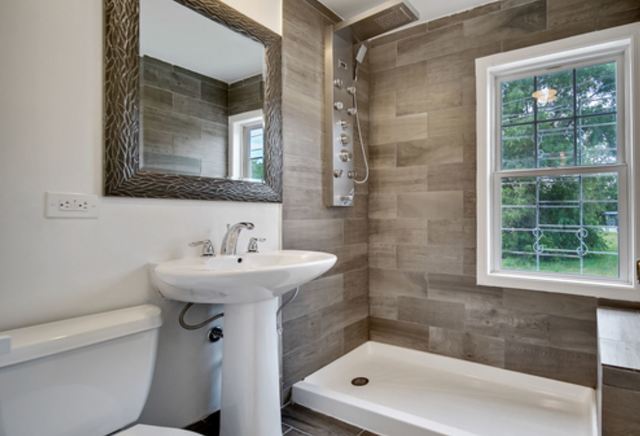 653 East 105th Street Chicago, IL 60628 - Photo 12 of 27 a bathroom with a sink mirror toilet and bathtub