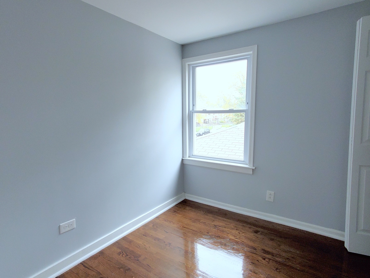 653 East 105th Street Chicago, IL 60628 - Photo 14 of 27 an empty room with wooden floor and windows