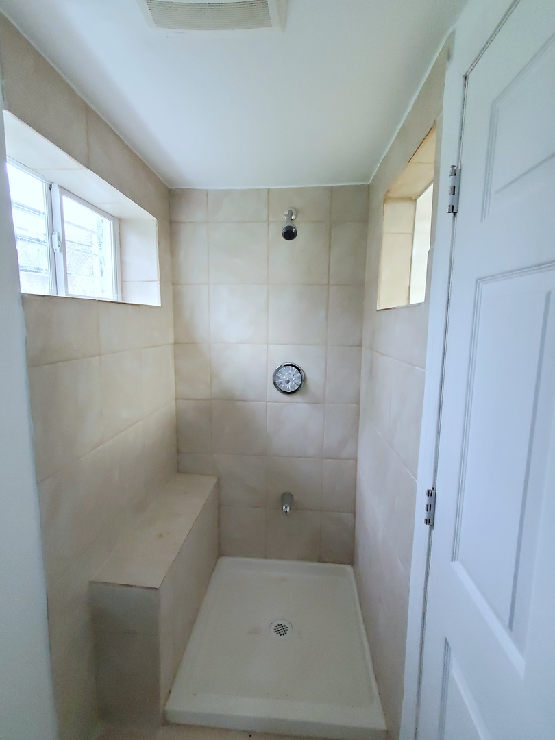 653 East 105th Street Chicago, IL 60628 - Photo 22 of 27 a bathroom with a toilet and shower
