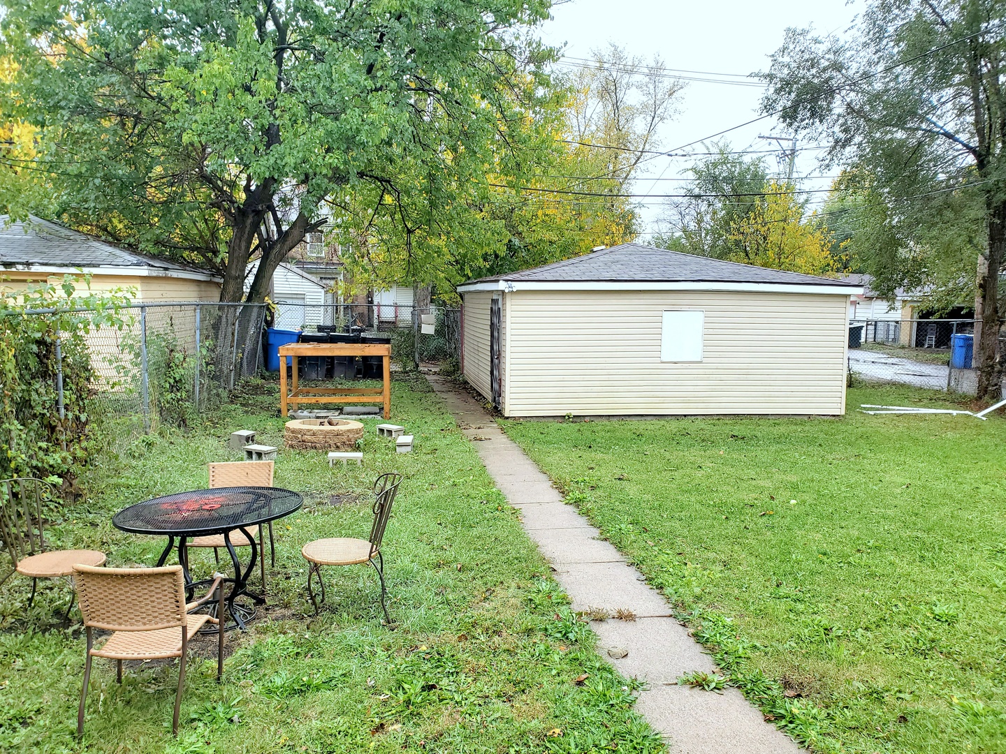 653 East 105th Street Chicago, IL 60628 - Photo 25 of 27 a backyard of a house with table and chairs