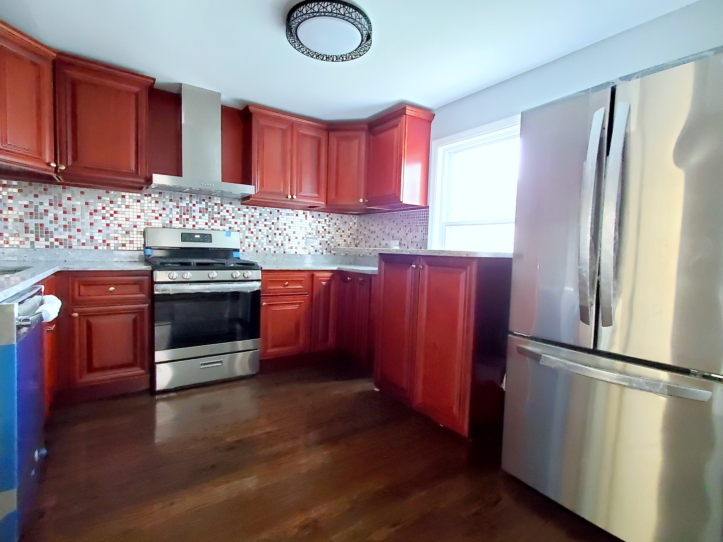 653 East 105th Street Chicago, IL 60628 - Photo 9 of 27 a kitchen with stainless steel appliances granite countertop a refrigerator a sink and wooden cabinets