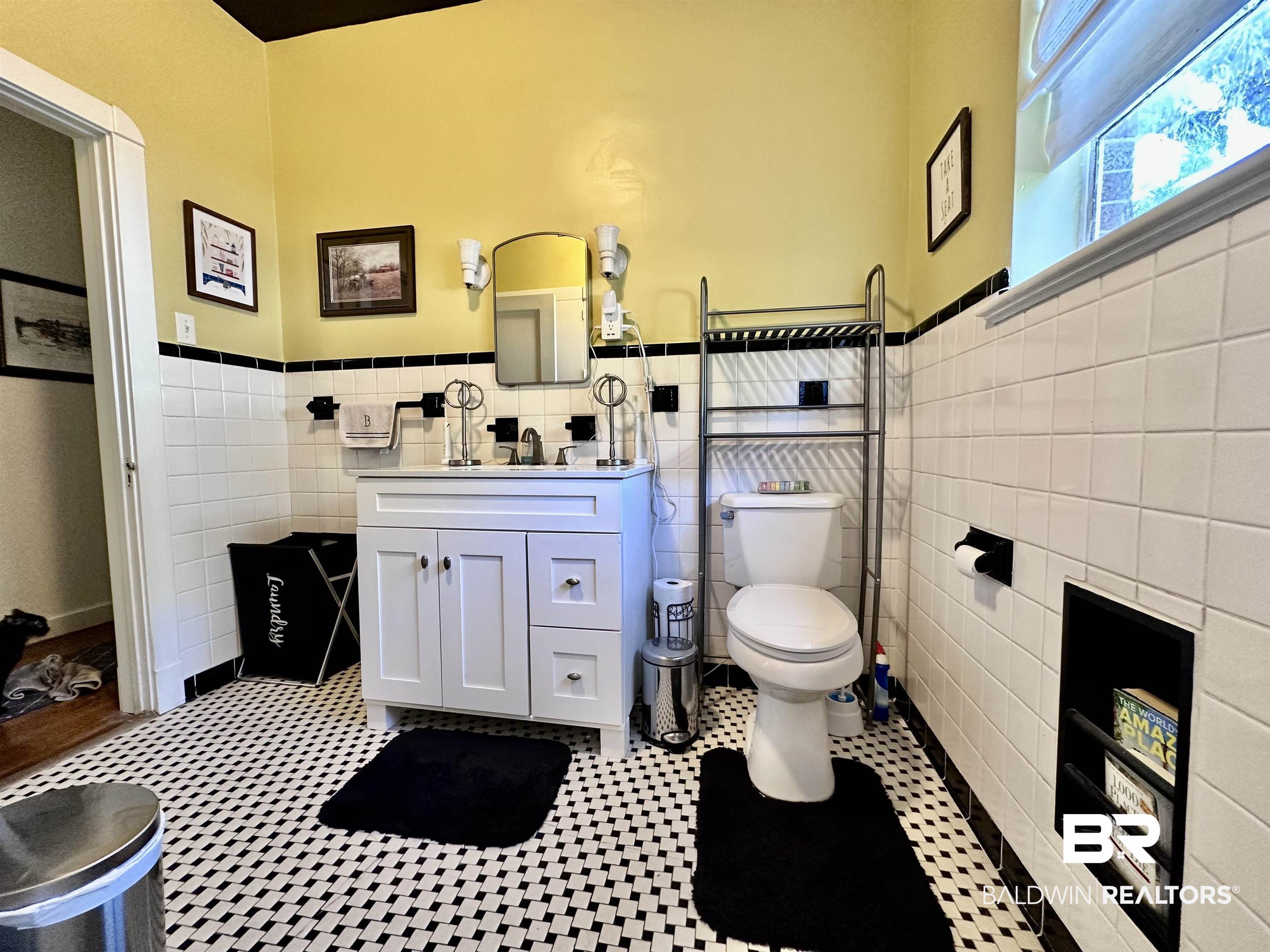 260 Siena Vista Street Mobile, AL 36607 - Photo 14 of 41 Bathroom featuring tile walls, vanity, toilet, and wainscoting