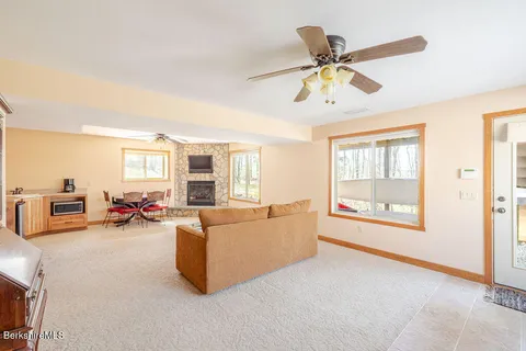 a living room with furniture and a floor to ceiling window
