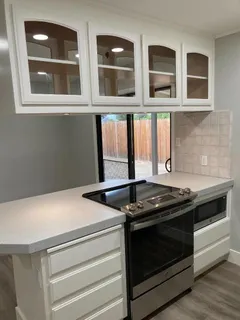 a kitchen with stainless steel appliances a stove and a microwave