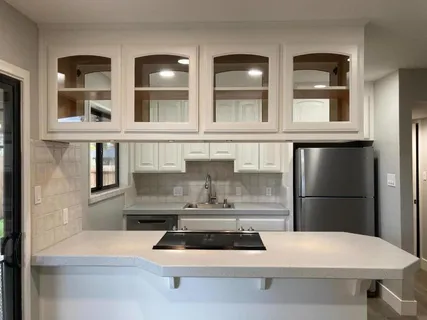 a kitchen with refrigerator and window