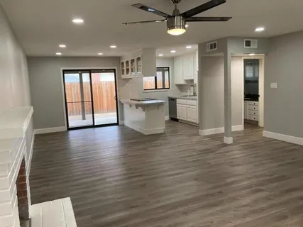a view of a kitchen with a sink and a refrigerator