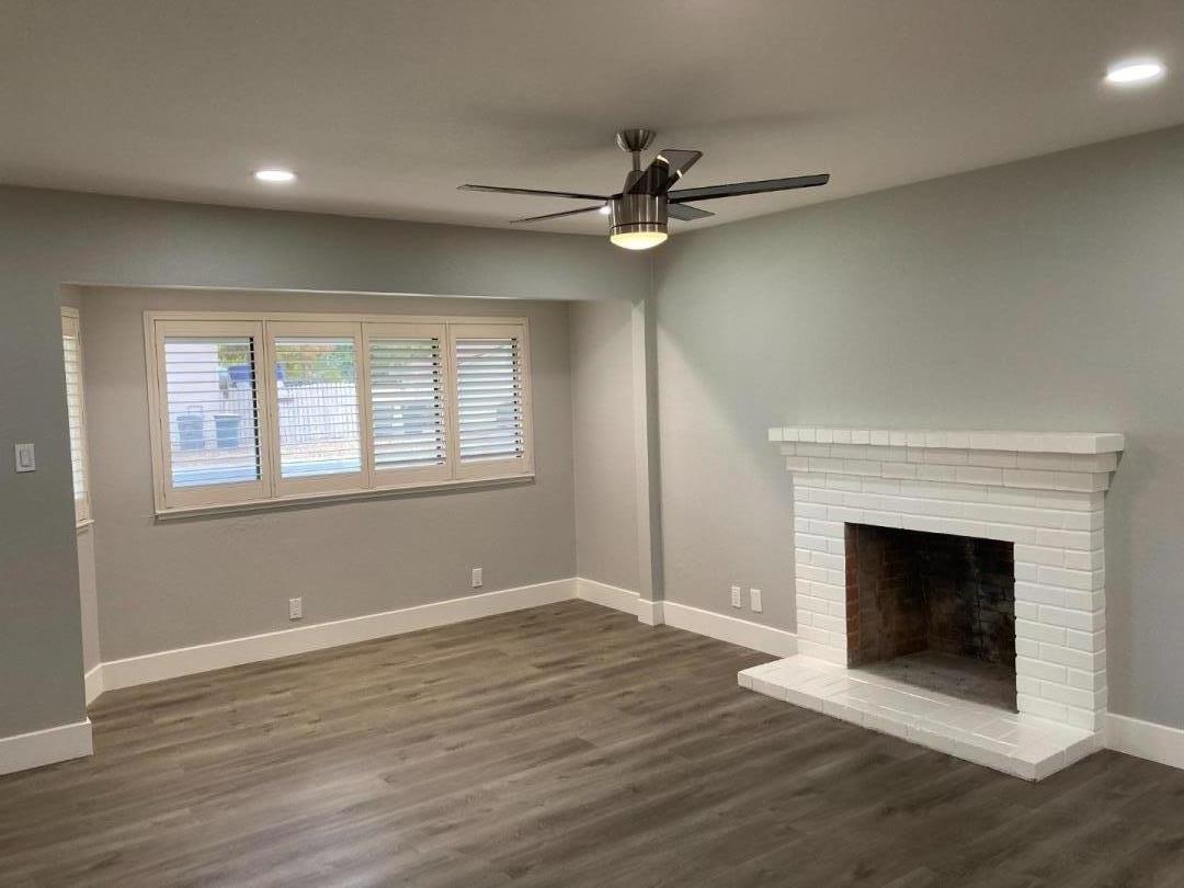 502 Oak Ridge Drive Roseville, CA 95661 - Photo 6 of 17 a view of an empty room with wooden floor fireplace and a window