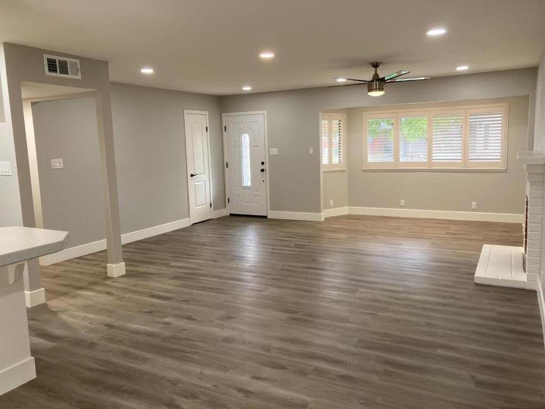 502 Oak Ridge Drive Roseville, CA 95661 - Photo 9 of 17 an empty room with wooden floor and windows