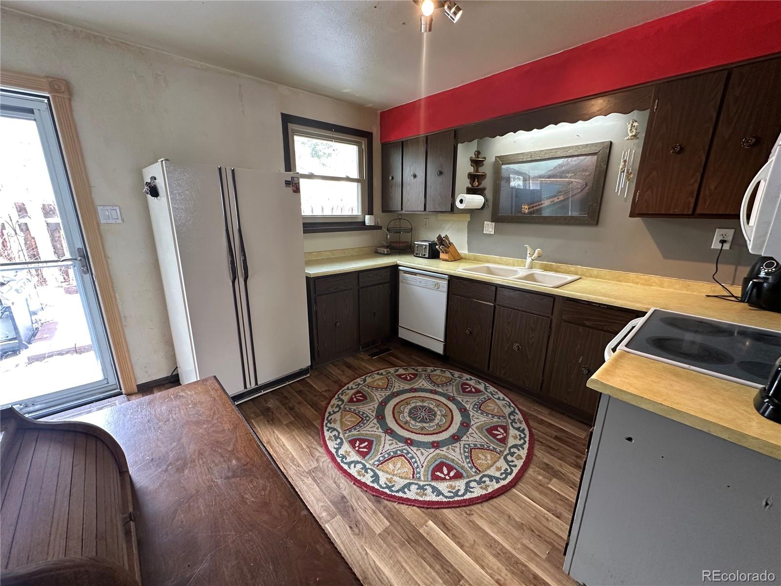 95 Empire West Road, Unit DA 52 Empire, CO 80438 - Photo 12 of 32 a kitchen with a stove a sink and a microwave