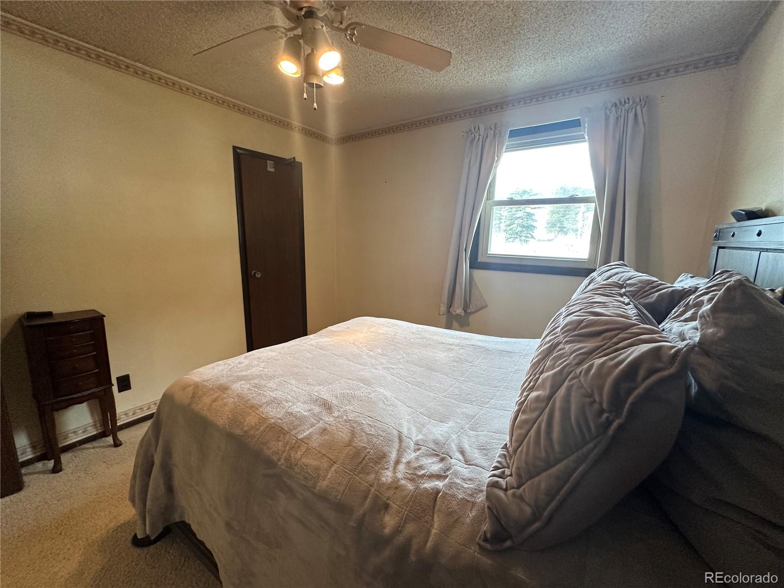 95 Empire West Road, Unit DA 52 Empire, CO 80438 - Photo 15 of 32 a bedroom with a bed and a chair