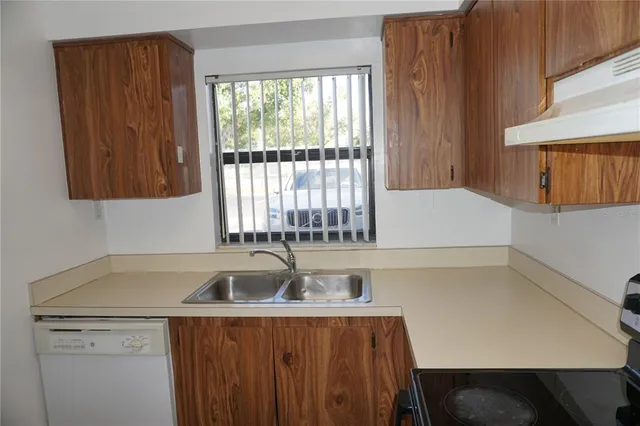 a kitchen with a sink and a window